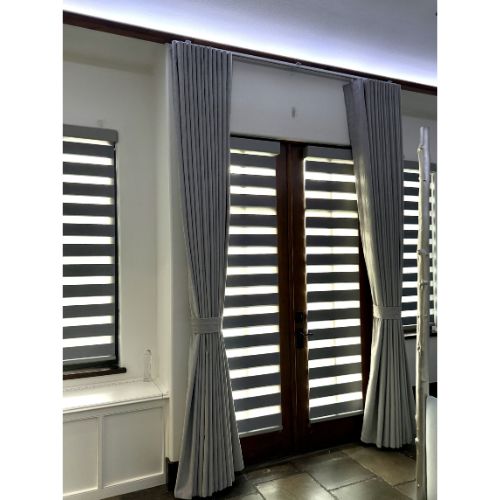 Blackout s pleat curtains on track and zebra blinds in master bedroom